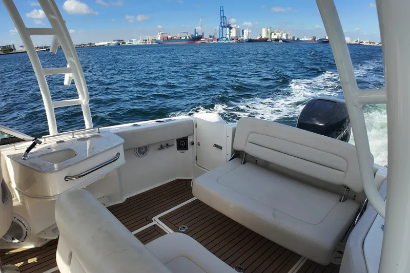 Slide: The Image of 2017 Boston Whaler 230 Vantage boat interior with ocean view and city skyline. - 18
