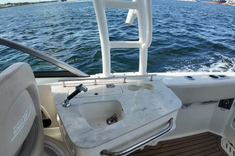 Slide: The Image of 2017 Boston Whaler 230 Vantage boat interior with sink and ocean view. - 19