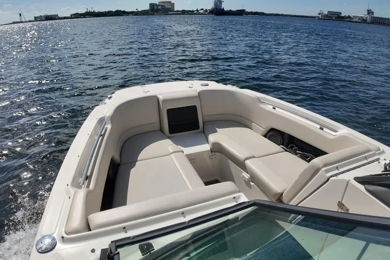 Slide: The Image of 2017 Boston Whaler 230 Vantage boat interior with cushioned seating on open water. - 22