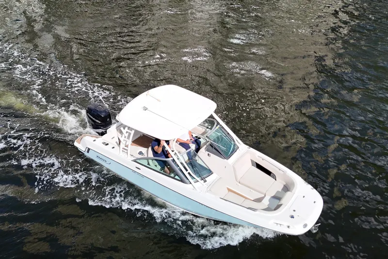 Slide: The Image of 2017 Boston Whaler 230 Vantage cruising on water, aerial view. - 7