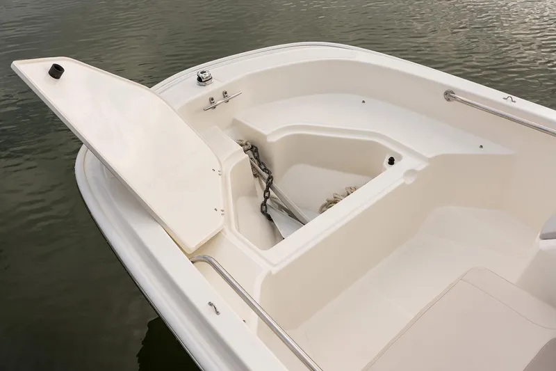 Slide: The Image of Manufacturer Provided Image: 2025 Boston Whaler 130 Super Sport boat interior with open storage compartment. - 16