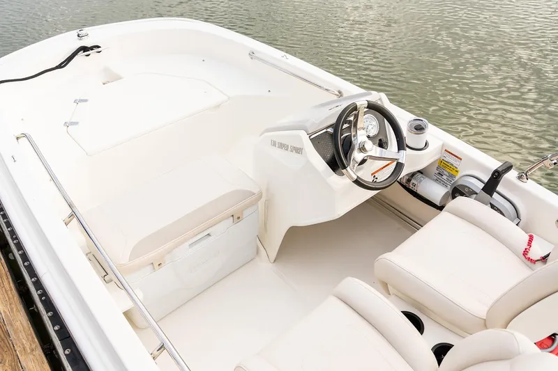 Slide: The Image of Manufacturer Provided Image: 2025 Boston Whaler 130 Super Sport boat interior with steering wheel and seating. - 17