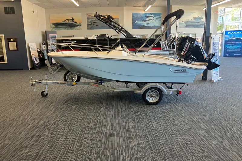 Slide: The Image of 2025 Boston Whaler 130 Super Sport boat on display in showroom. - 3