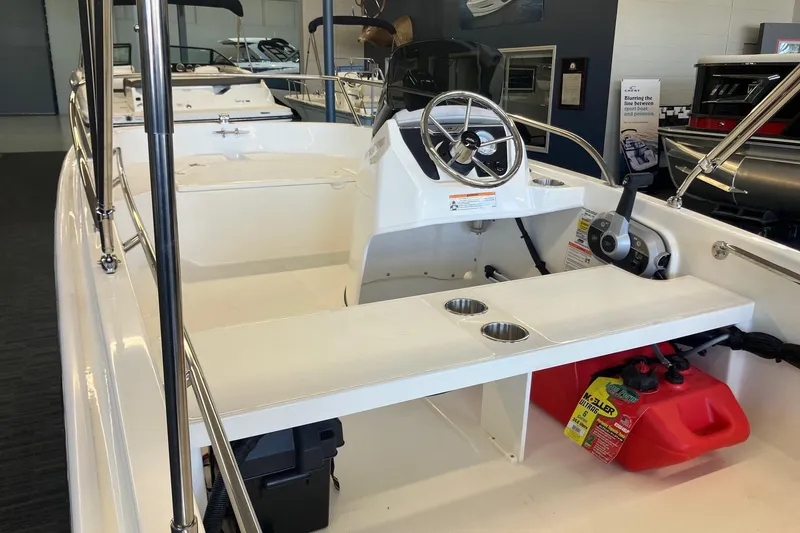 Slide: The Image of 2025 Boston Whaler 130 Super Sport interior with steering wheel and seating area. - 6