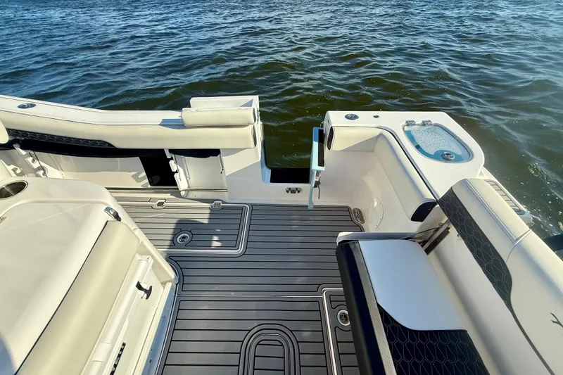 Slide: The Image of 2024 Tidewater 320 CC Adventure boat deck with seating and water view. - 11