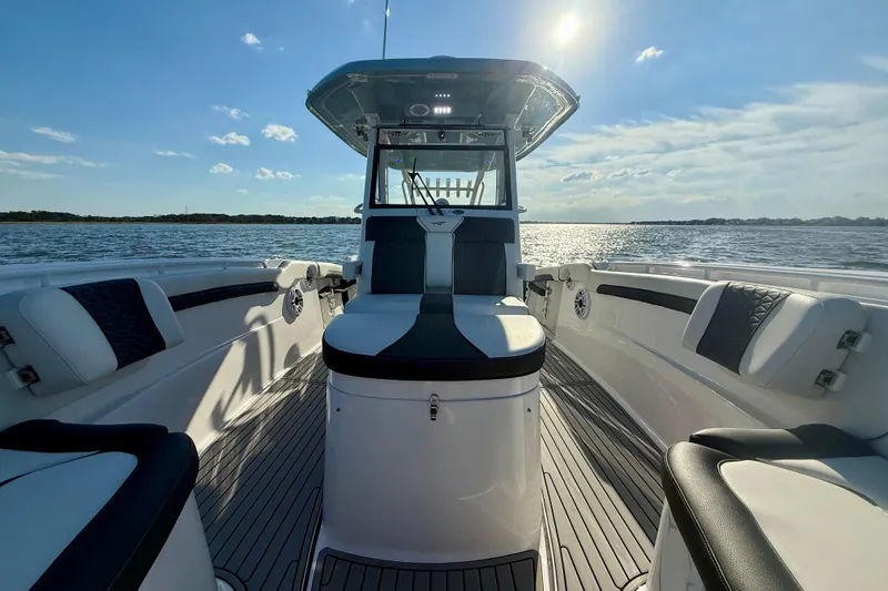 Slide: The Image of 2024 Tidewater 320 CC Adventure boat interior on a sunny day at sea. - 12