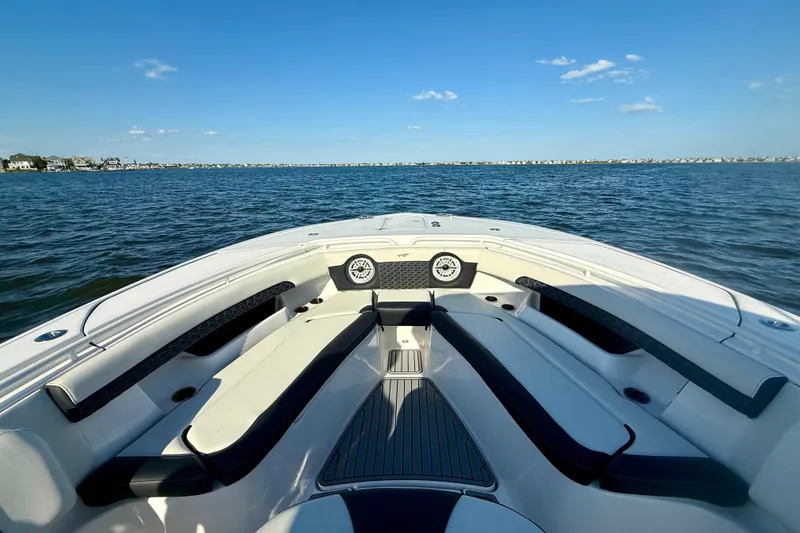 Slide: The Image of 2024 Tidewater 320 CC Adventure boat interior with seating, on open water. - 15