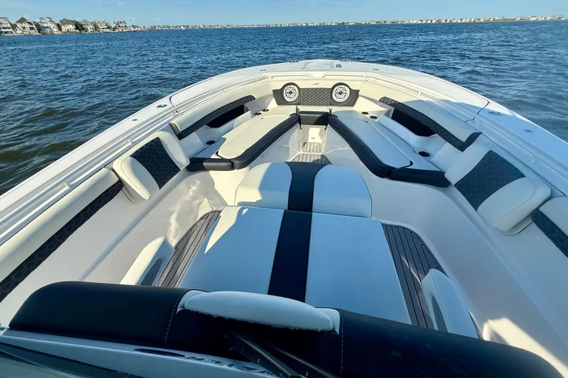 Slide: The Image of 2024 Tidewater 320 CC Adventure boat interior with luxurious seating on open water. - 17