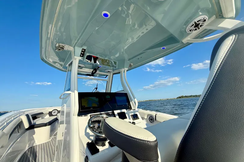 Slide: The Image of 2024 Tidewater 320 CC Adventure boat interior with advanced navigation system on open water. - 20