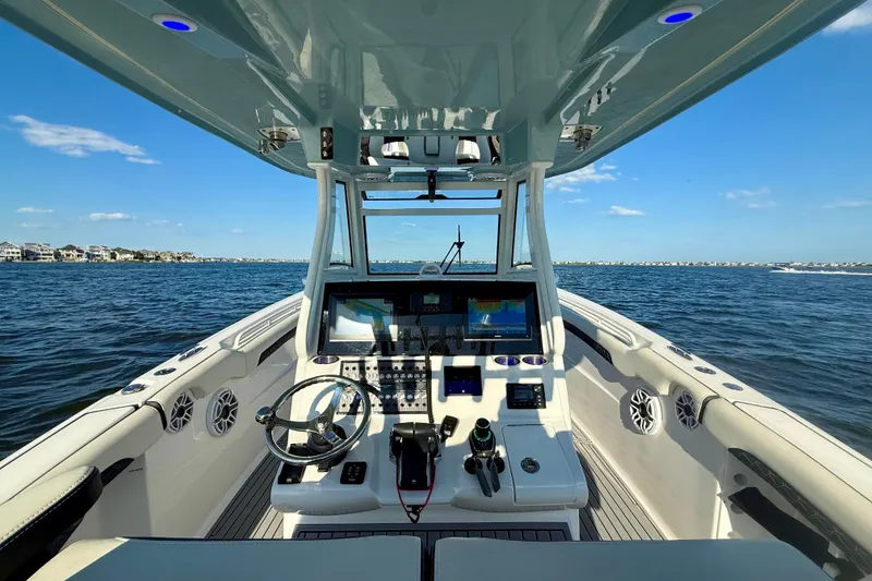 Slide: The Image of 2024 Tidewater 320 CC Adventure boat interior with advanced navigation system on open water. - 21