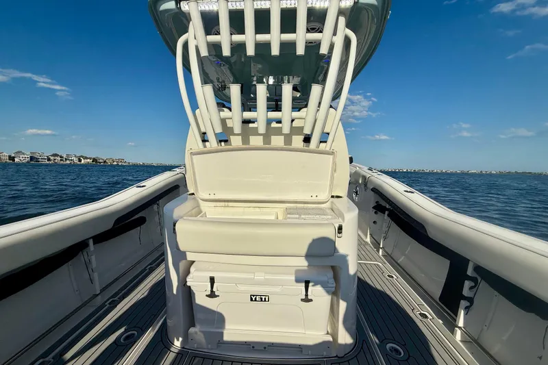 Slide: The Image of 2024 Tidewater 320 CC Adventure boat on water, featuring spacious deck and YETI cooler. - 22