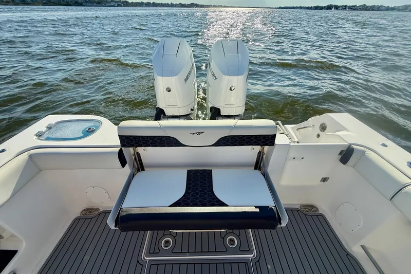 Slide: The Image of 2024 Tidewater 320 CC Adventure boat with dual Mercury engines on open water. - 24