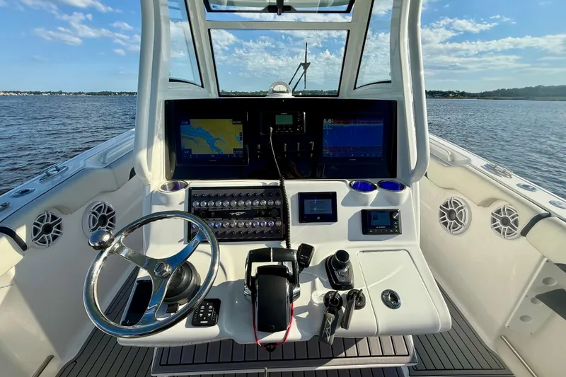 Slide: The Image of 2024 Tidewater 320 CC Adventure boat helm with advanced navigation and control systems. - 32