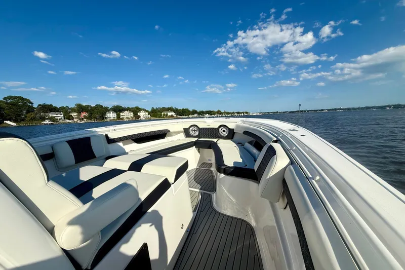Slide: The Image of 2024 Tidewater 320 CC Adventure boat interior with luxurious seating on a sunny day. - 33