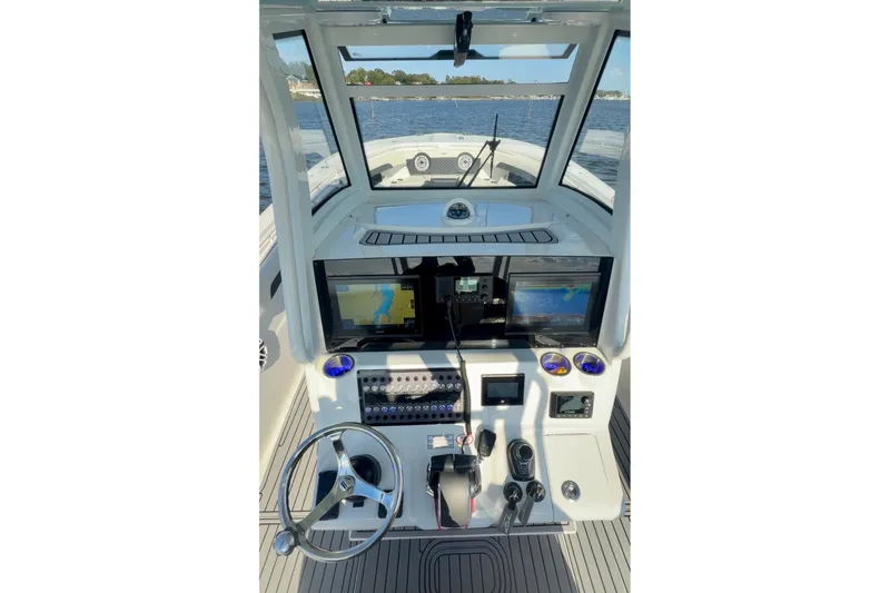 Slide: The Image of 2024 Tidewater 320 CC Adventure boat dashboard with navigation screens and controls. - 35