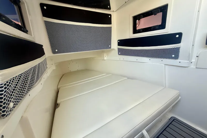 Slide: The Image of 2024 Tidewater 320 CC Adventure cabin interior with cushioned seating and storage nets. - 39