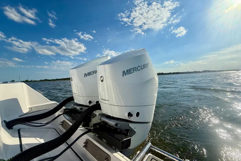 Slide: The Image of 2024 Tidewater 320 CC Adventure with dual Mercury outboard engines on open water. - 4