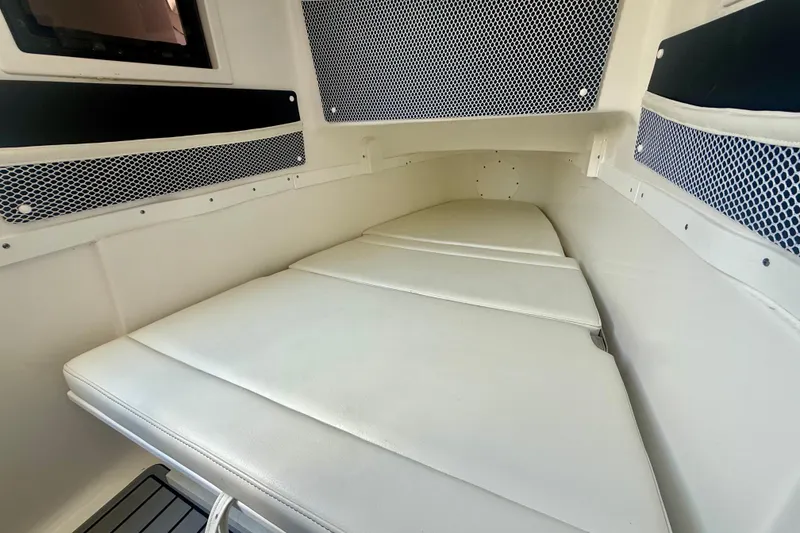Slide: The Image of 2024 Tidewater 320 CC Adventure cabin interior with cushioned seating and storage nets. - 41