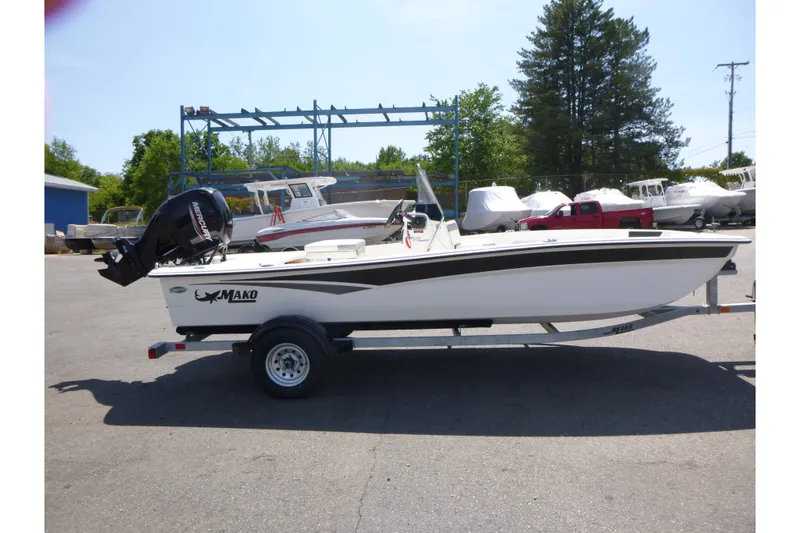 The Image of 2024 Mako Pro Skiff 17 CC boat on trailer, parked outdoors. - 1