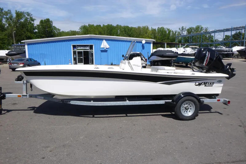 Slide: The Image of 2024 Mako Pro Skiff 17 CC boat on trailer outside showroom. - 4