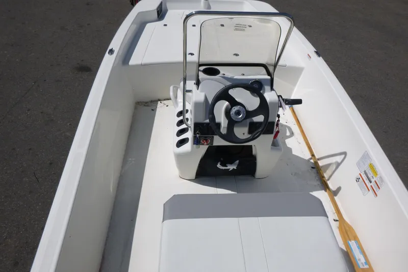 Slide: The Image of 2024 Mako Pro Skiff 17 CC boat interior with steering console and seating. - 5