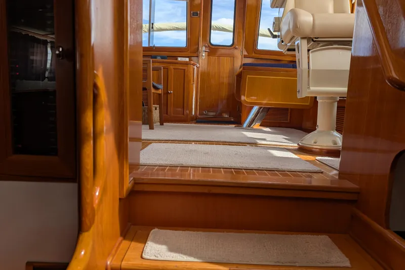 Slide: The Image of Interior of 2006 Grand Banks 49 Eastbay SX yacht with wooden finishes and seating. - 54