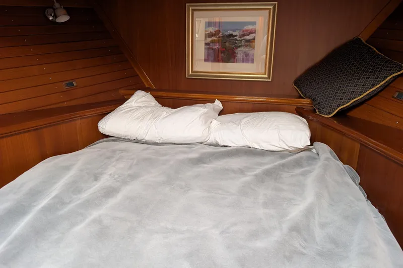 Slide: The Image of Cozy cabin bedroom in 2006 Grand Banks 49 Eastbay SX yacht with wooden paneling. - 62