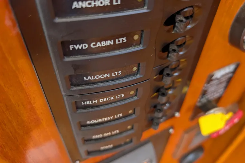Slide: The Image of Control panel of 2006 Grand Banks 49 Eastbay SX yacht with labeled switches. - 38