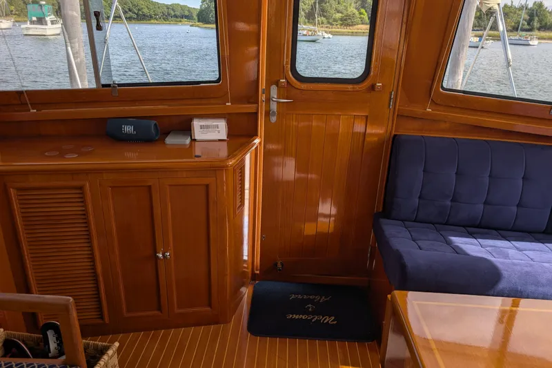 Slide: The Image of Interior of 2006 Grand Banks 49 Eastbay SX yacht with wooden cabinetry and blue seating. - 41