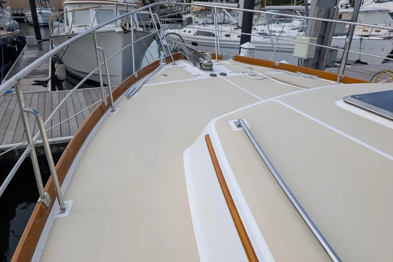 Slide: The Image of 2006 Grand Banks 49 Eastbay SX yacht deck with railing, docked at marina. - 5