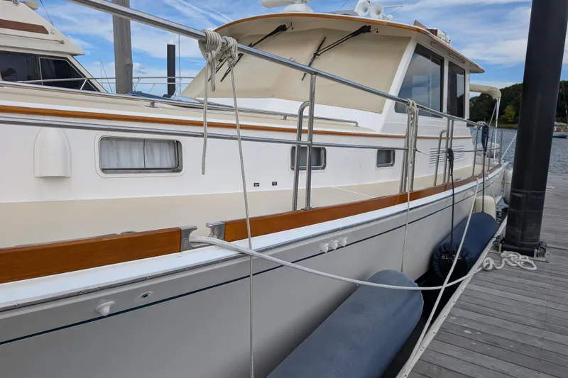 Slide: The Image of 2006 Grand Banks 49 Eastbay SX yacht docked at marina, side view. - 2