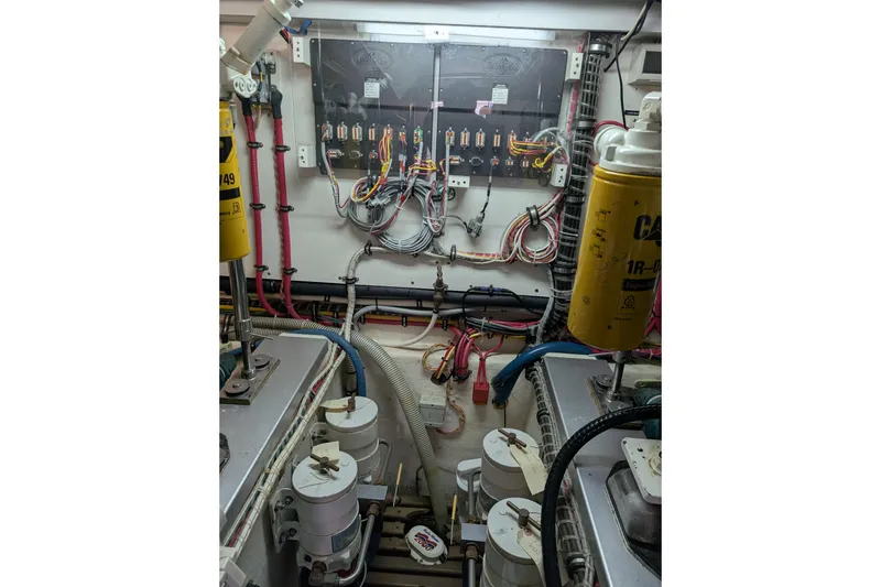 Slide: The Image of Engine room of 2006 Grand Banks 49 Eastbay SX with wiring and filters visible. - 67