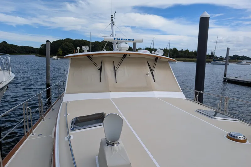 Slide: The Image of 2006 Grand Banks 49 Eastbay SX yacht docked at marina under blue sky. - 4