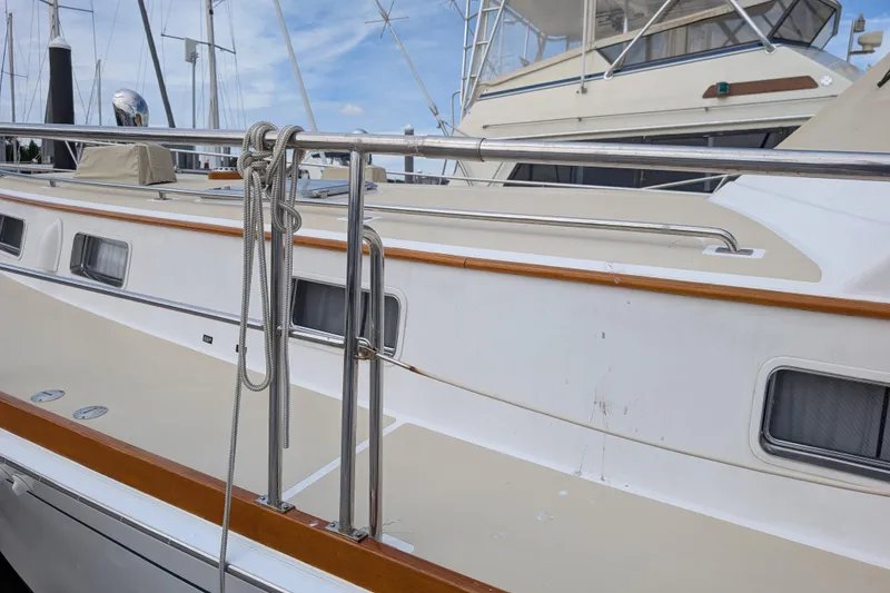 Slide: The Image of 2006 Grand Banks 49 Eastbay SX yacht deck with railing and mooring lines. - 14