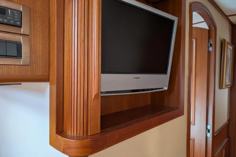 Slide: The Image of Flat-screen TV in wooden cabinet on 2006 Grand Banks 49 Eastbay SX yacht interior. - 64