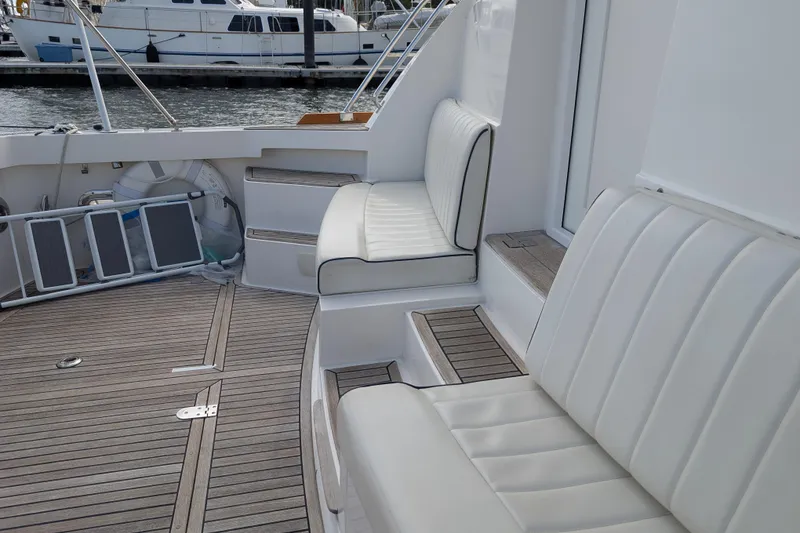 Slide: The Image of 2006 Grand Banks 49 Eastbay SX yacht with white seating and teak deck. - 15