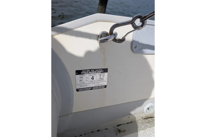 Slide: The Image of 2006 Grand Banks 49 Eastbay SX boat capacity label and metal hook detail. - 71