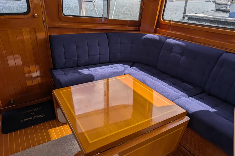 Slide: The Image of Luxurious interior of 2006 Grand Banks 49 Eastbay SX with blue seating and wooden table. - 40