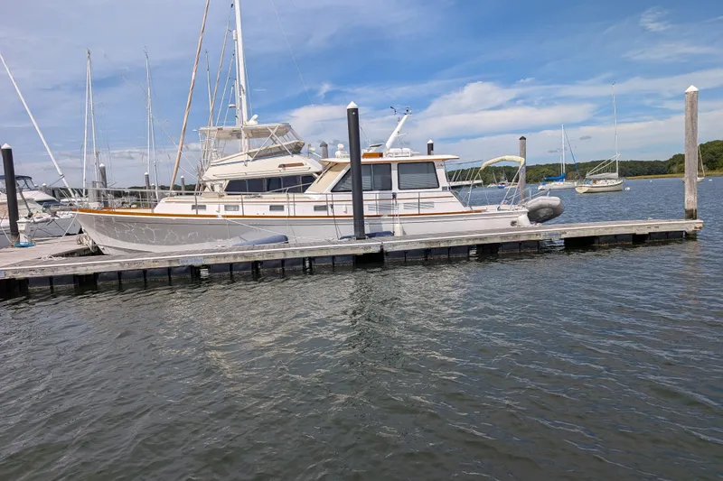 Slide: The Image of 2006 Grand Banks 49 Eastbay SX yacht docked at marina under blue sky. - 72