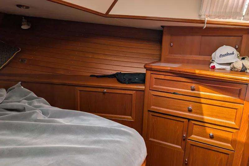 Slide: The Image of Cozy cabin interior of 2006 Grand Banks 49 Eastbay SX with wooden cabinetry and bed. - 61