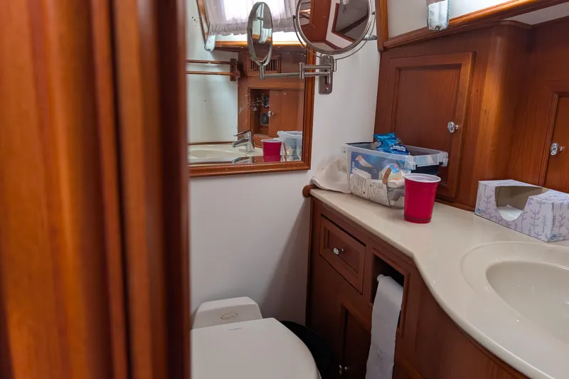 Slide: The Image of Luxurious 2006 Grand Banks 49 Eastbay SX yacht bathroom with wooden cabinetry and modern amenities. - 59