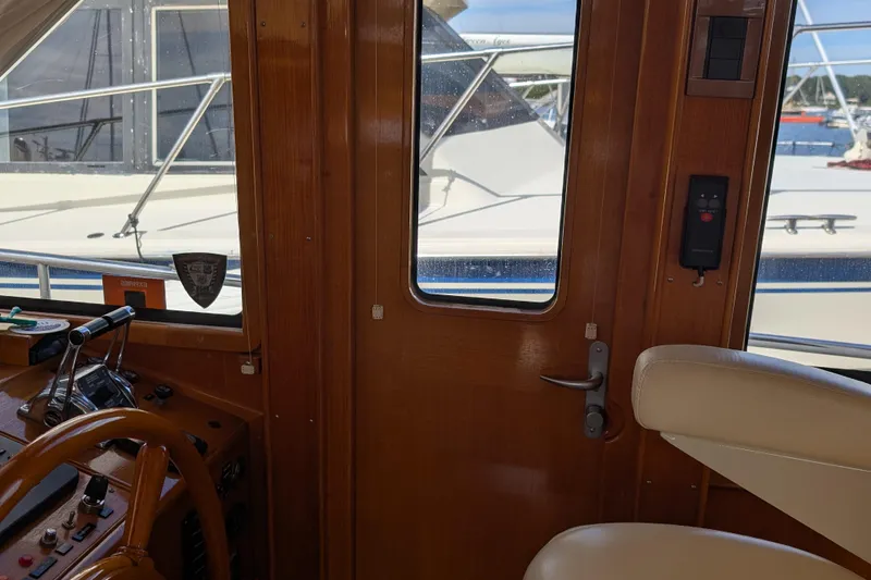 Slide: The Image of Interior view of 2006 Grand Banks 49 Eastbay SX yacht helm with wooden finish. - 28