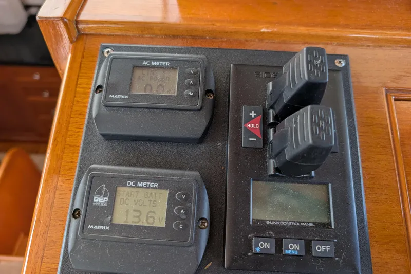 Slide: The Image of Control panel of a 2006 Grand Banks 49 Eastbay SX with AC and DC meters. - 35