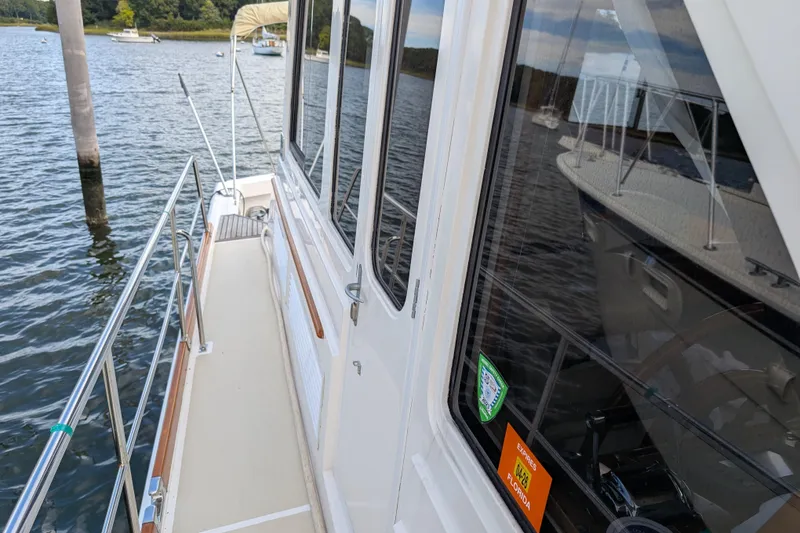 Slide: The Image of 2006 Grand Banks 49 Eastbay SX yacht docked on calm water. - 9