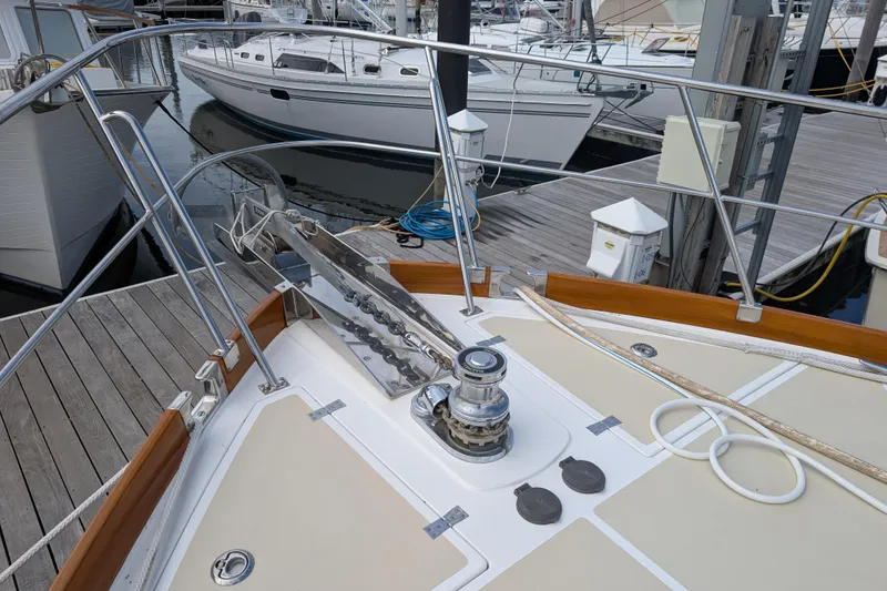 Slide: The Image of 2006 Grand Banks 49 Eastbay SX yacht bow with anchor and winch at marina. - 10