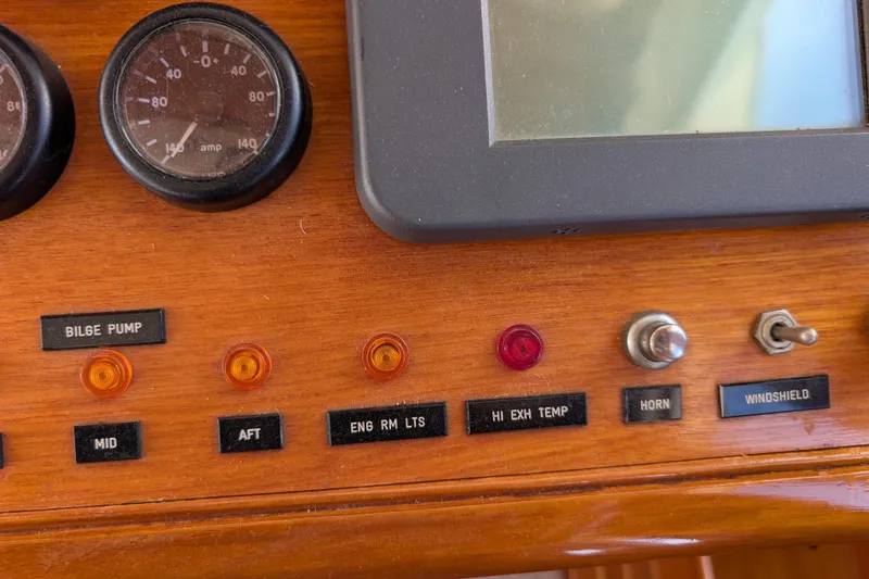 Slide: The Image of 2006 Grand Banks 49 Eastbay SX dashboard with gauges, switches, and indicator lights. - 34