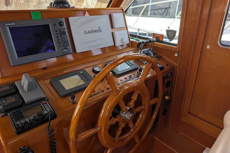 Slide: The Image of Helm of 2006 Grand Banks 49 Eastbay SX with navigation equipment and wooden steering wheel. - 26