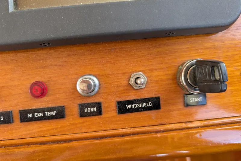 Slide: The Image of Control panel of a 2006 Grand Banks 49 Eastbay SX with switches and ignition key. - 33