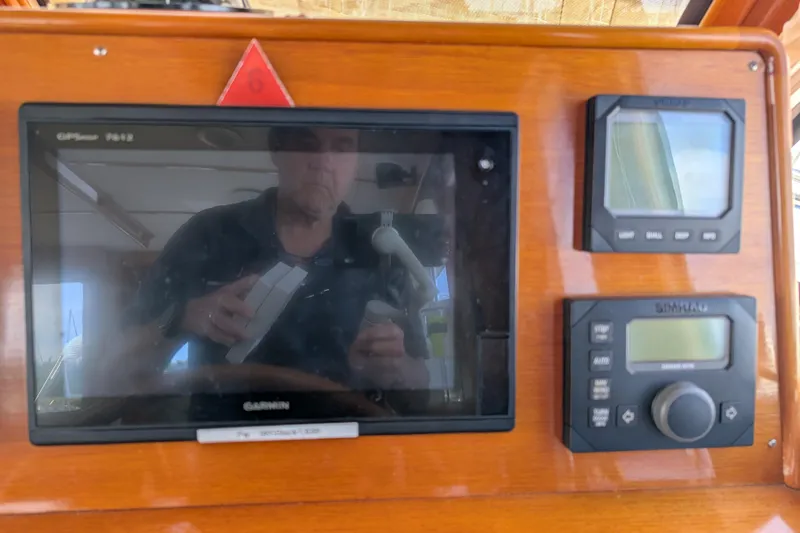 Slide: The Image of 2006 Grand Banks 49 Eastbay SX dashboard with Garmin and Simrad navigation displays. - 31