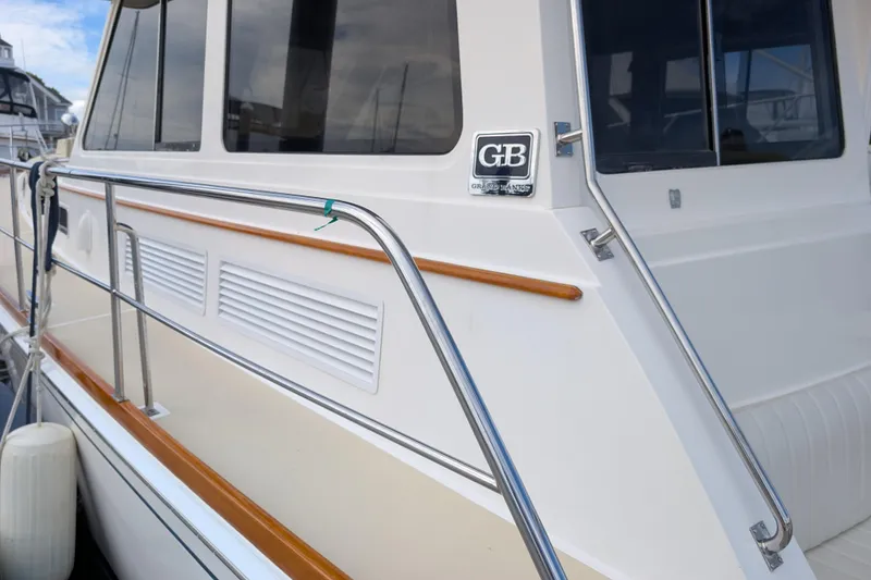 Slide: The Image of 2006 Grand Banks 49 Eastbay SX yacht with sleek design and polished railings. - 13